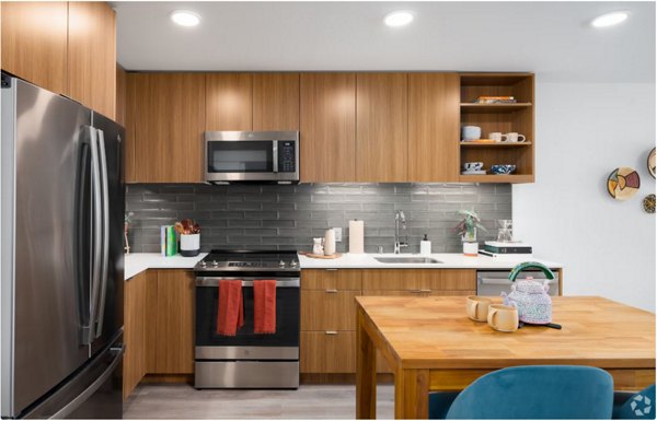 Arlo Apartments: Modern kitchen with stainless steel appliances and granite countertops