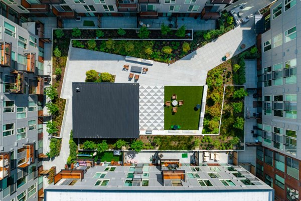 Arlo Apartments: Modern luxury apartments with sleek facade and greenery in urban setting