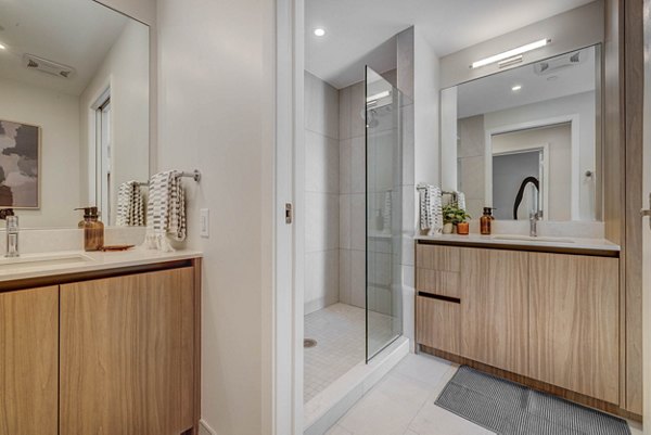 Bathroom featuring sleek tiles and modern fixtures at The Worthington Apartments