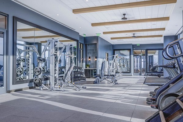 Fully-equipped fitness center with state-of-the-art machines at The Worthington Apartments, offering luxury living in a vibrant community