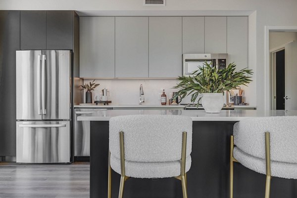 Kitchen with granite countertops and stainless steel appliances at The Worthington Apartments Luxury living space for modern cooking experiences