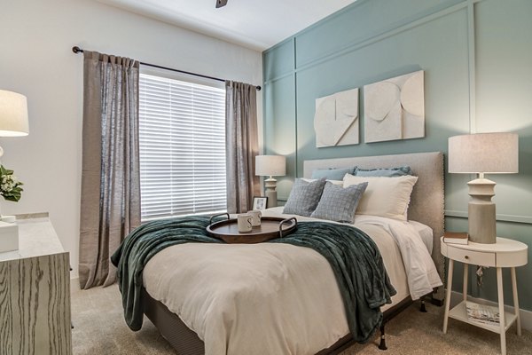 Modern bedroom with ample natural light in Solis Gainesville Apartments