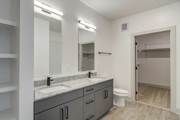 Modern bathroom featuring sleek fixtures and ample lighting at Solis Gainesville Apartments