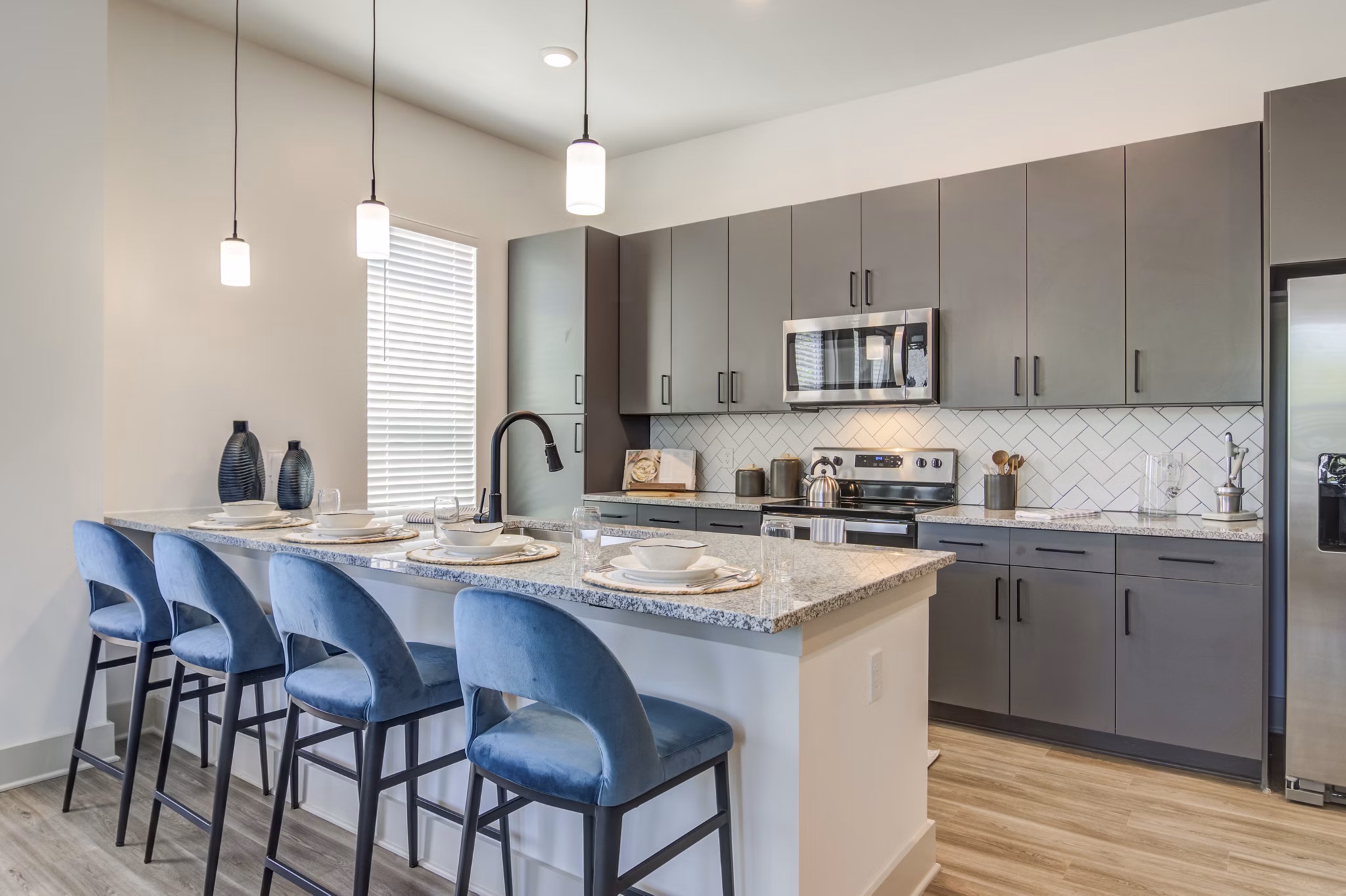 Modern kitchen with sleek cabinetry and stainless steel appliances in Solis Gainesville Apartments