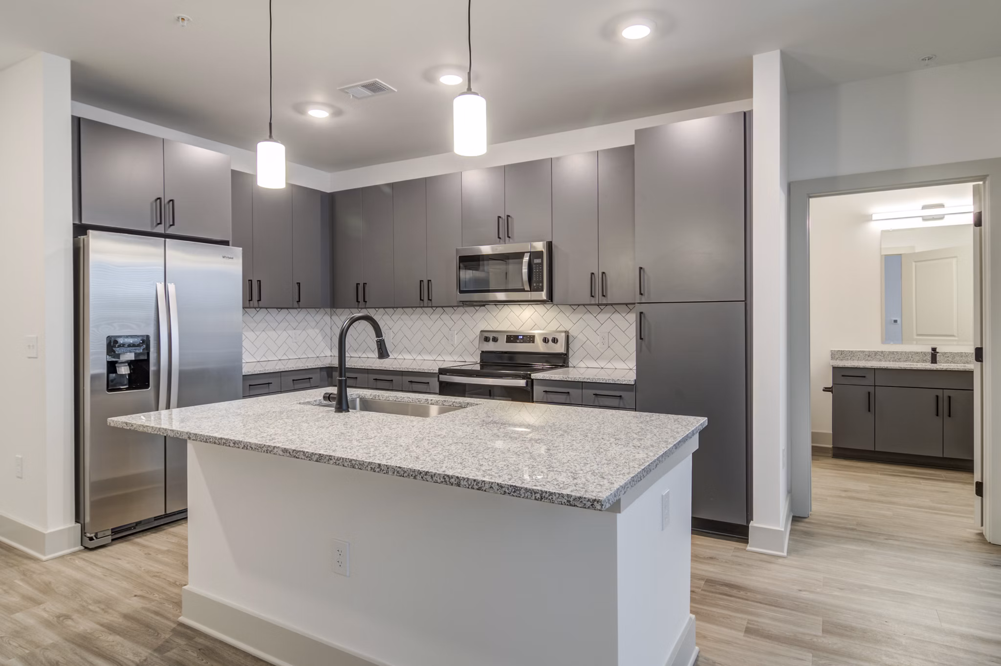 Modern kitchen with sleek countertops and stainless steel appliances at Solis Gainesville Apartments