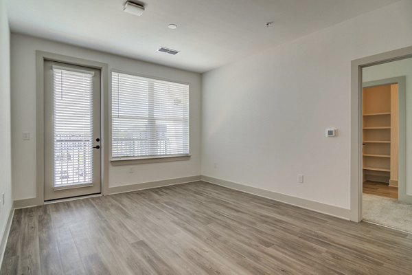 Living room featuring modern furnishings and large windows in Solis Gainesville Apartments