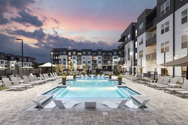 Scenic pool with loungers at Solis Gainesville Apartments, offering a luxurious retreat in the heart of Gainesville