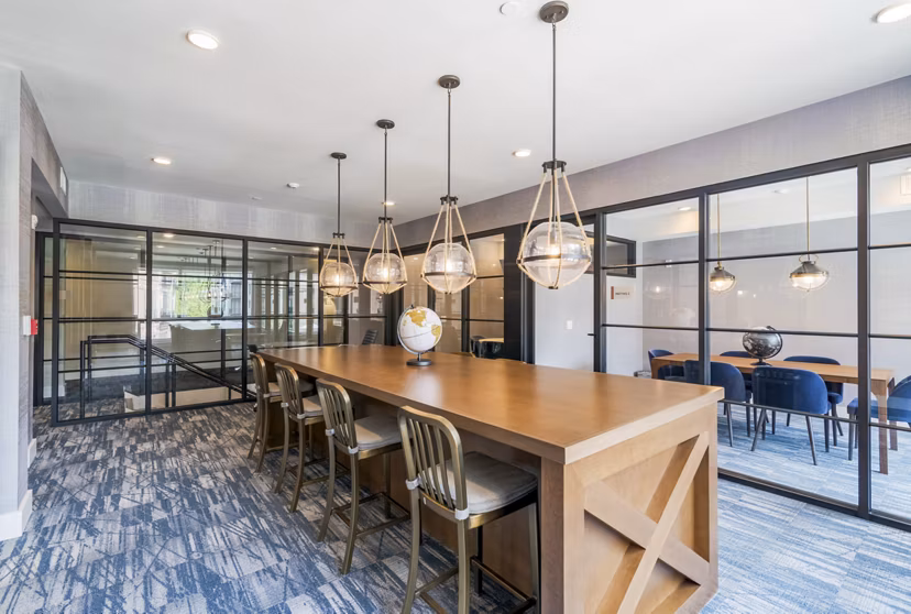 Clubhouse with modern design and ample seating at Riverside Wilton Apartments