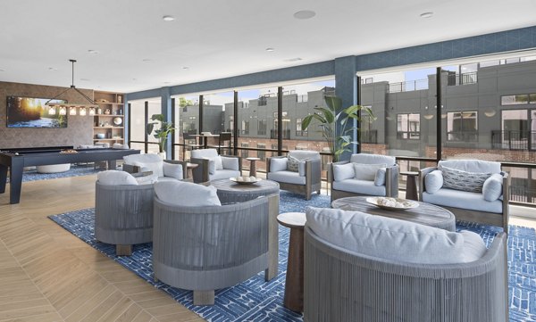 Elegant clubhouse at Riverside Wilton Apartments featuring modern decor and stylish seating areas