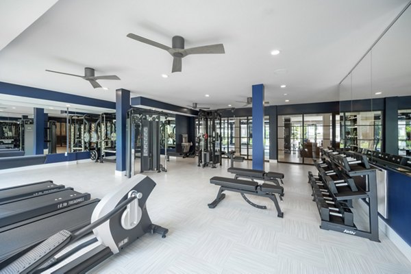 Fitness room with modern equipment at Riverside Wilton Apartments
