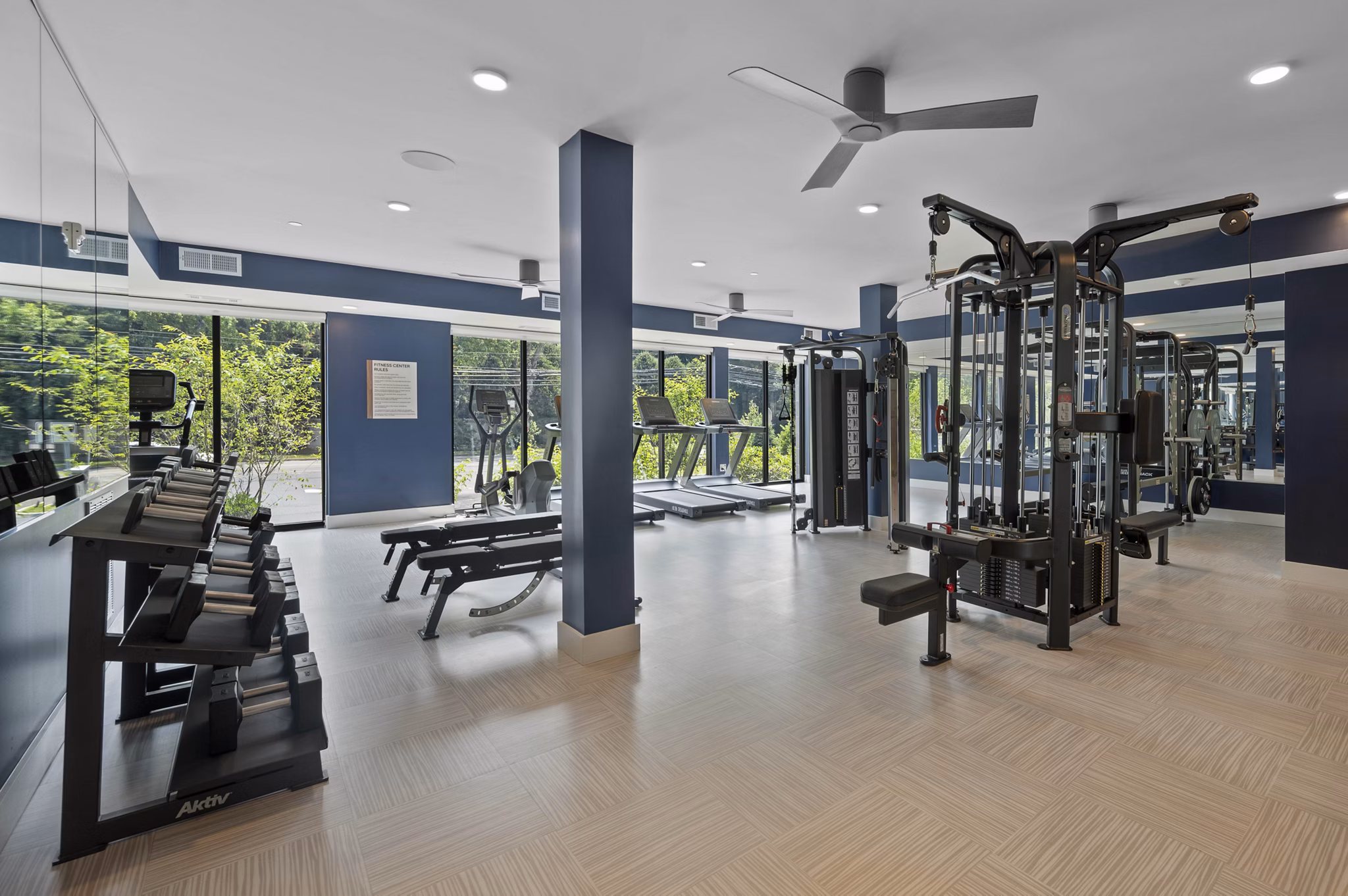 State-of-the-art fitness room with modern equipment at Riverside Wilton Apartments