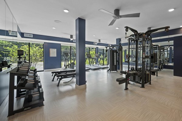 State-of-the-art fitness room with modern equipment at Riverside Wilton Apartments