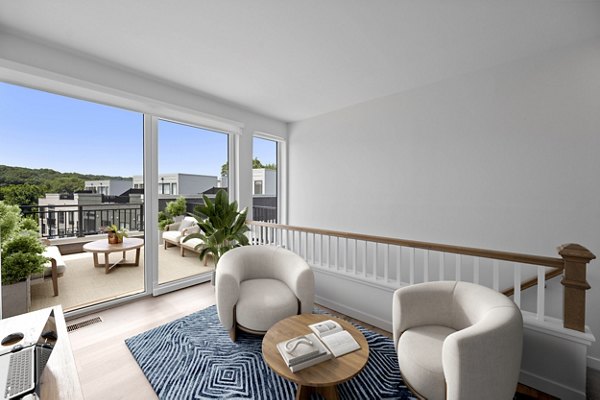 Spacious living room with modern furnishings in Riverside Wilton Apartments, a Greystar luxury apartment community