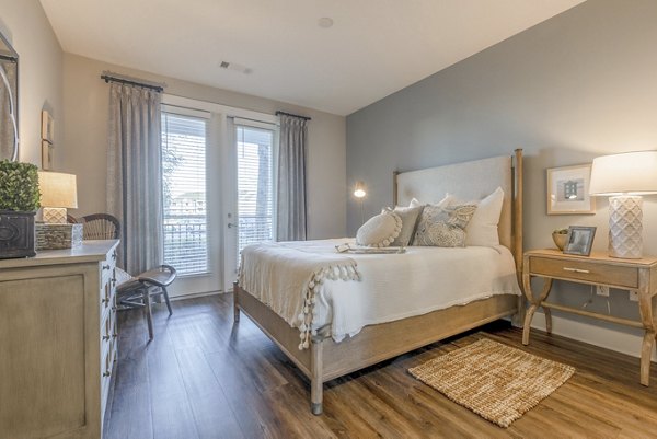 Bedroom featuring modern decor and ample natural light at Newbrook Point Hope Apartments