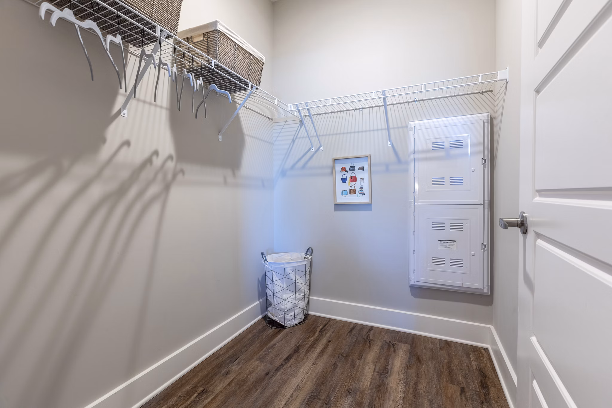 Walk-in closet with built-in shelves at Newbrook Point Hope Apartments - stylish storage solutions in luxury living spaces