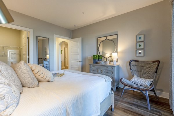 Cozy bedroom in Newbrook Point Hope Apartments with modern furnishings and soft lighting, creating a luxurious living space