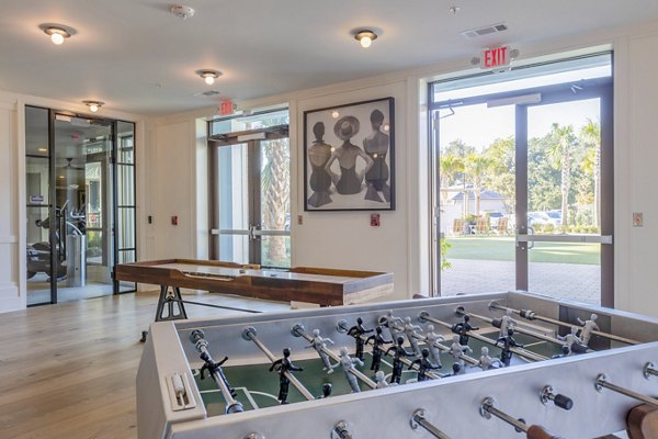 Game room with pool table and arcade games at Newbrook Point Hope Apartments, a luxury community with amenities for entertainment and relaxation