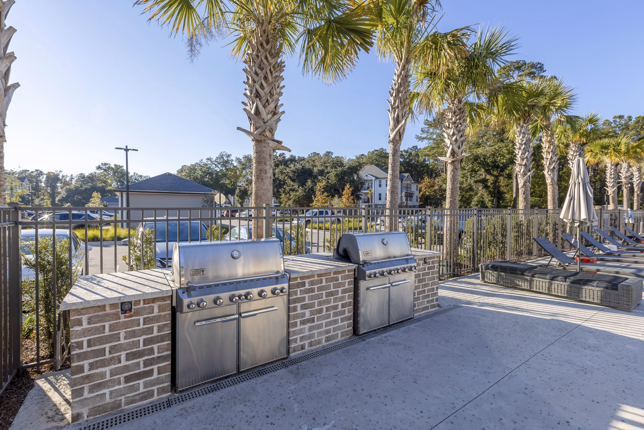 Grill area with modern seating at Newbrook Point Hope Apartments, perfect for outdoor dining and relaxation