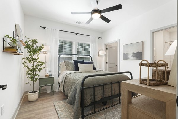 Cozy bedroom with natural light and modern decor at Waterside at Pepper Hall Apartments