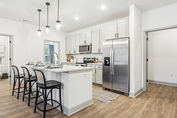 Modern kitchen with stainless steel appliances at Waterside at Pepper Hall Apartments, offering luxury living spaces near  activities