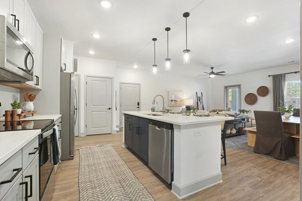 Modern kitchen with stainless steel appliances at Waterside at Pepper Hall Apartments