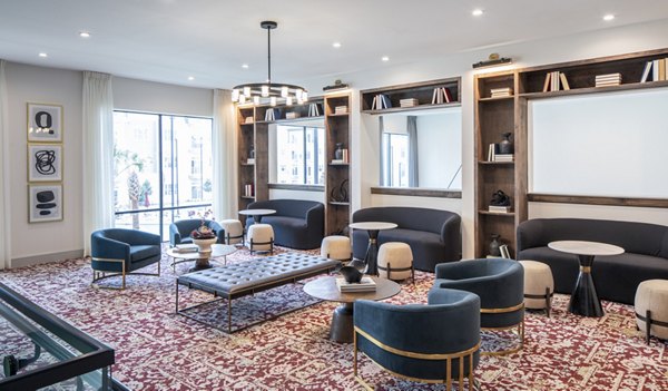 Clubhouse with modern seating and game area at Broadstone Frontera Ridge Apartments