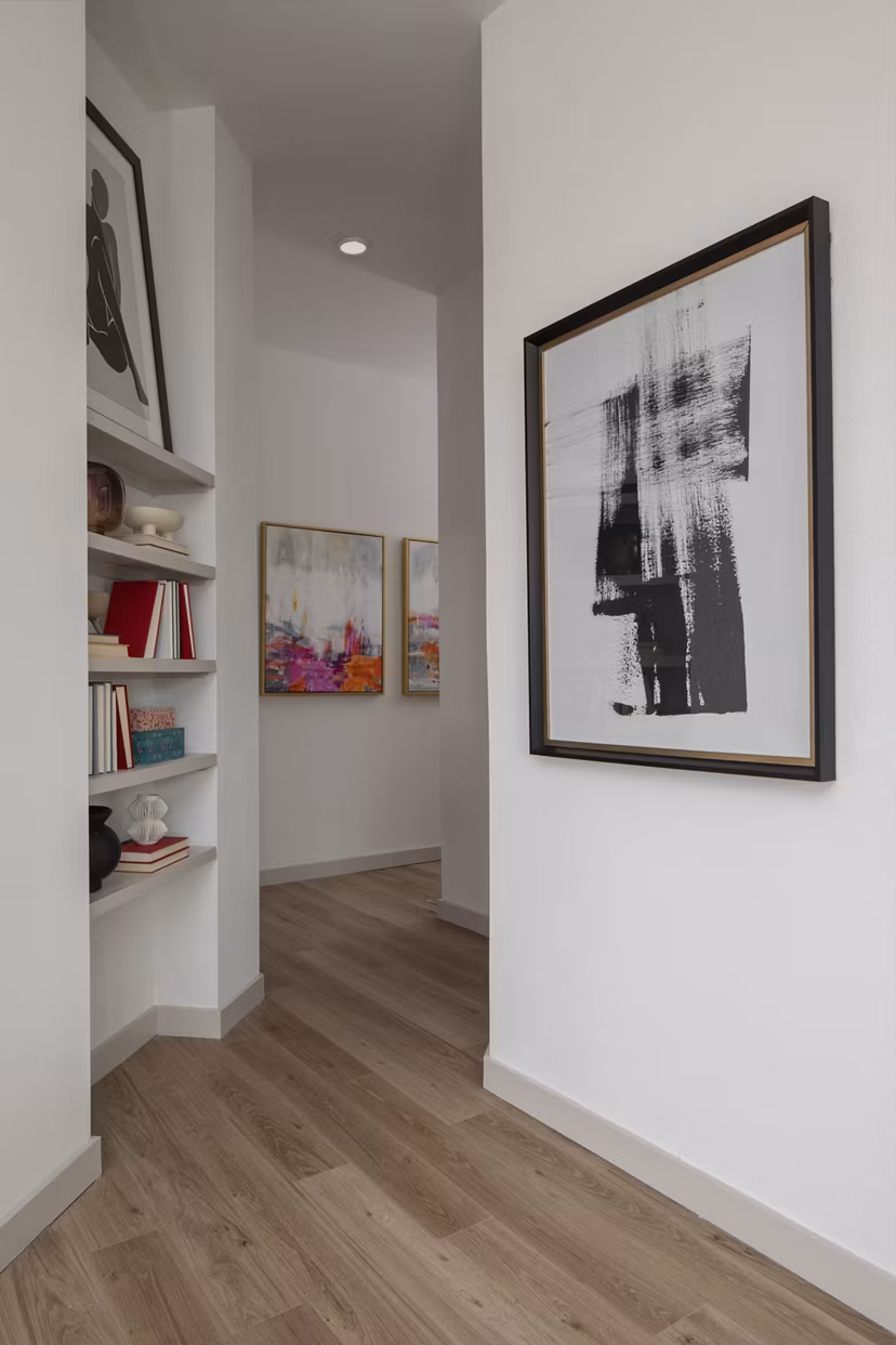 Hallway with modern lighting and artwork at Broadstone Frontera Ridge Apartments