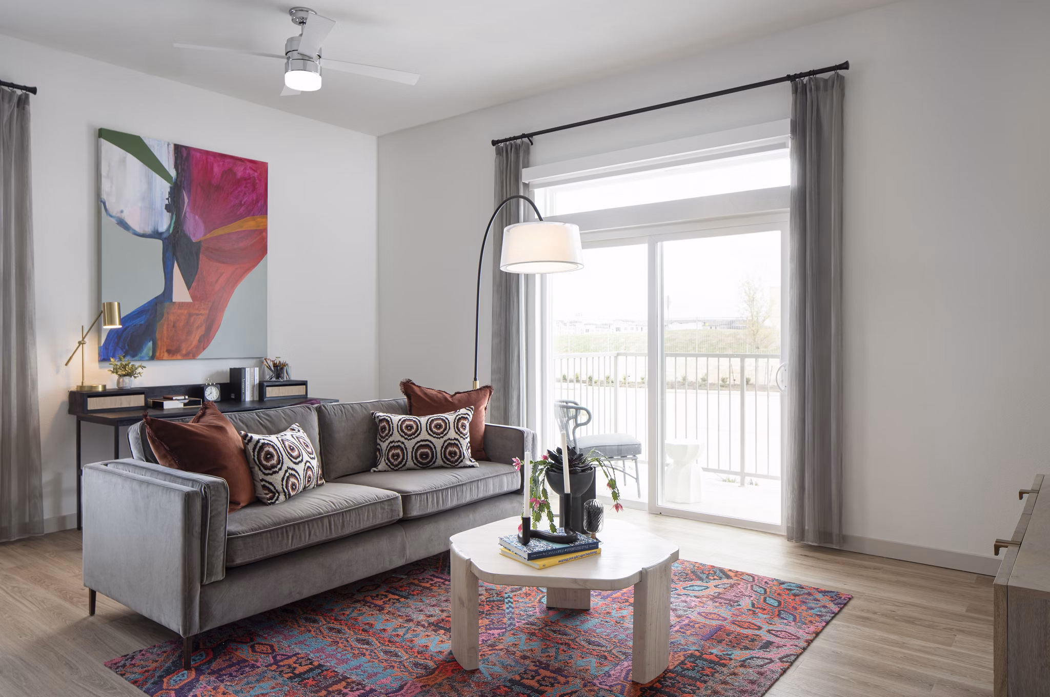Living room with modern decor and large windows at Broadstone Frontera Ridge Apartments