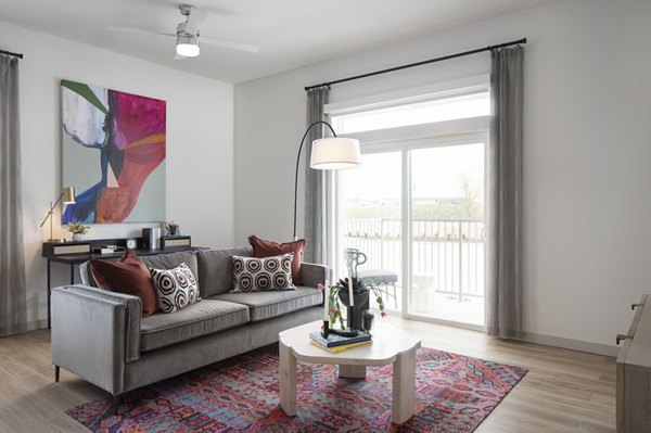 Living room with modern decor and large windows at Broadstone Frontera Ridge Apartments