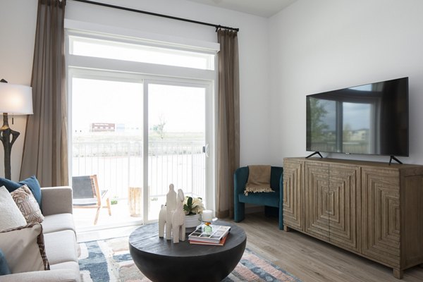 Spacious living room with modern design and natural light in Broadstone Frontera Ridge Apartments