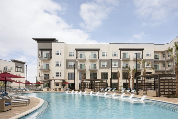 Stylish pool with lounge chairs at Broadstone Frontera Ridge Apartments, an upscale community for relaxation and leisure