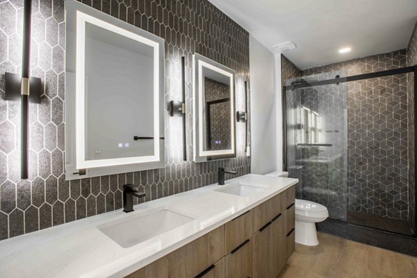 Luxurious bathroom with modern fixtures at Elliston 23 Apartments, featuring elegant design and spacious layout