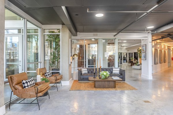 Clubhouse featuring modern lounge areas and games at Elliston 23 Apartments