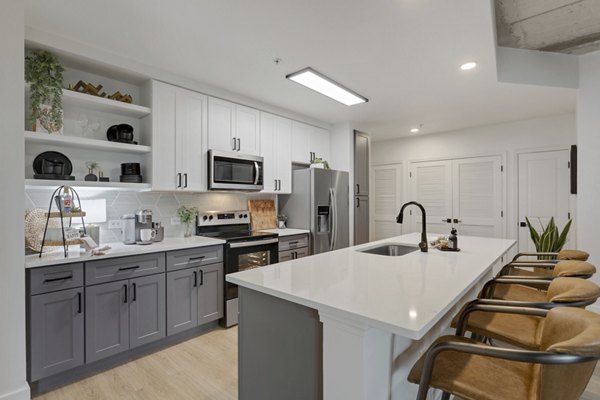 Modern kitchen with stainless steel appliances at Elliston 23 Apartments
