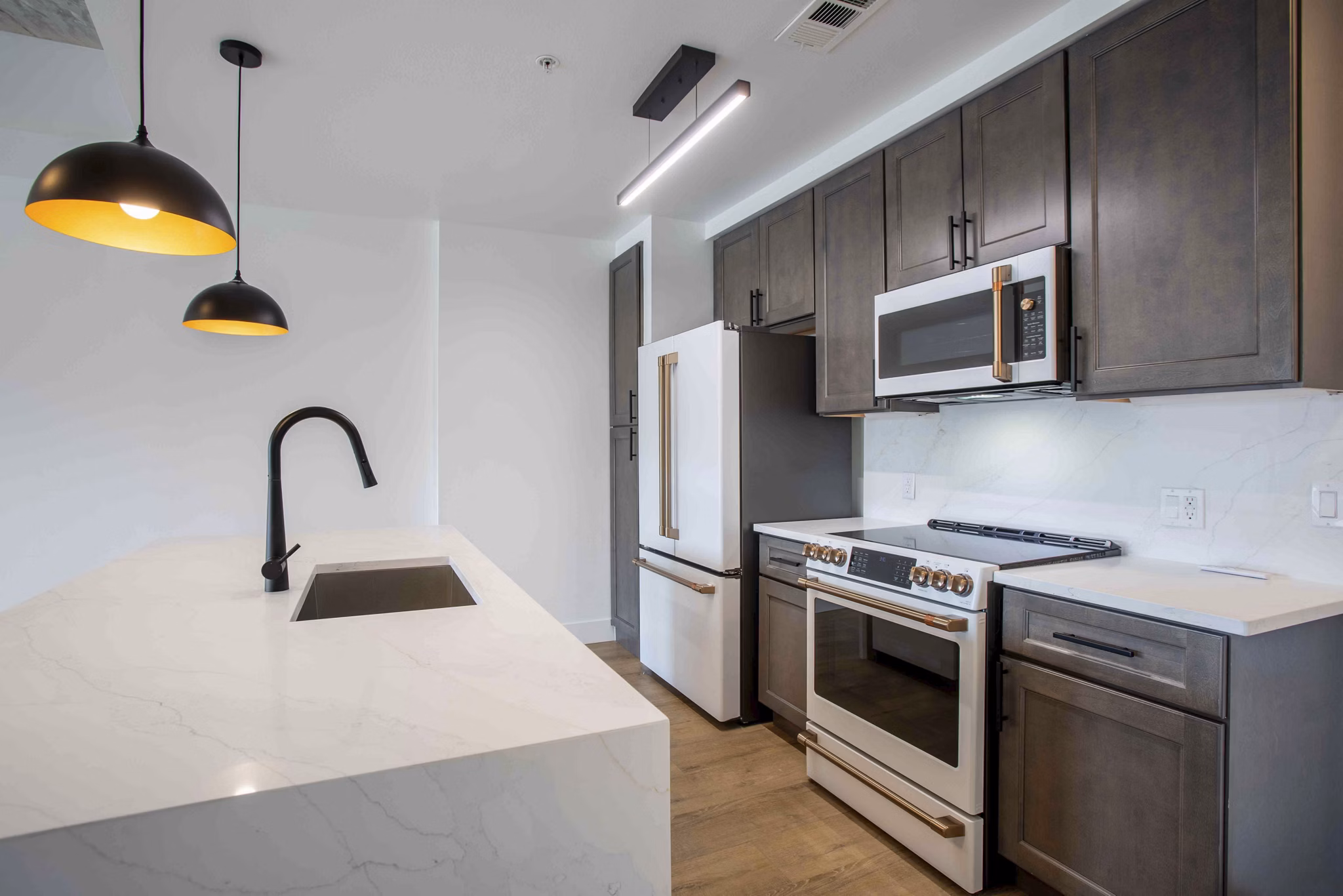Modern kitchen with stainless steel appliances and granite countertops at Elliston 23 Apartments