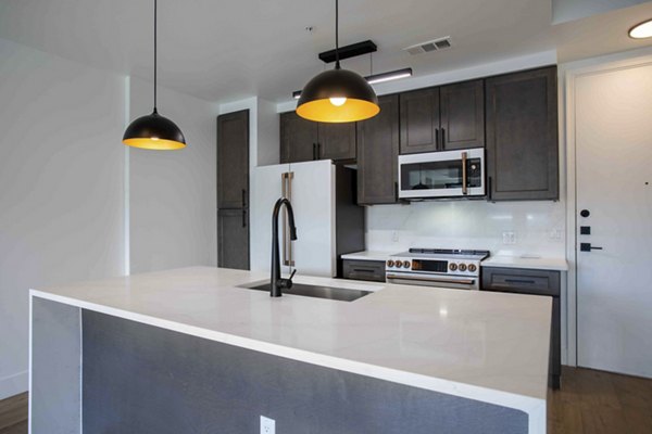 Modern kitchen with stainless steel appliances at Elliston 23 Apartments