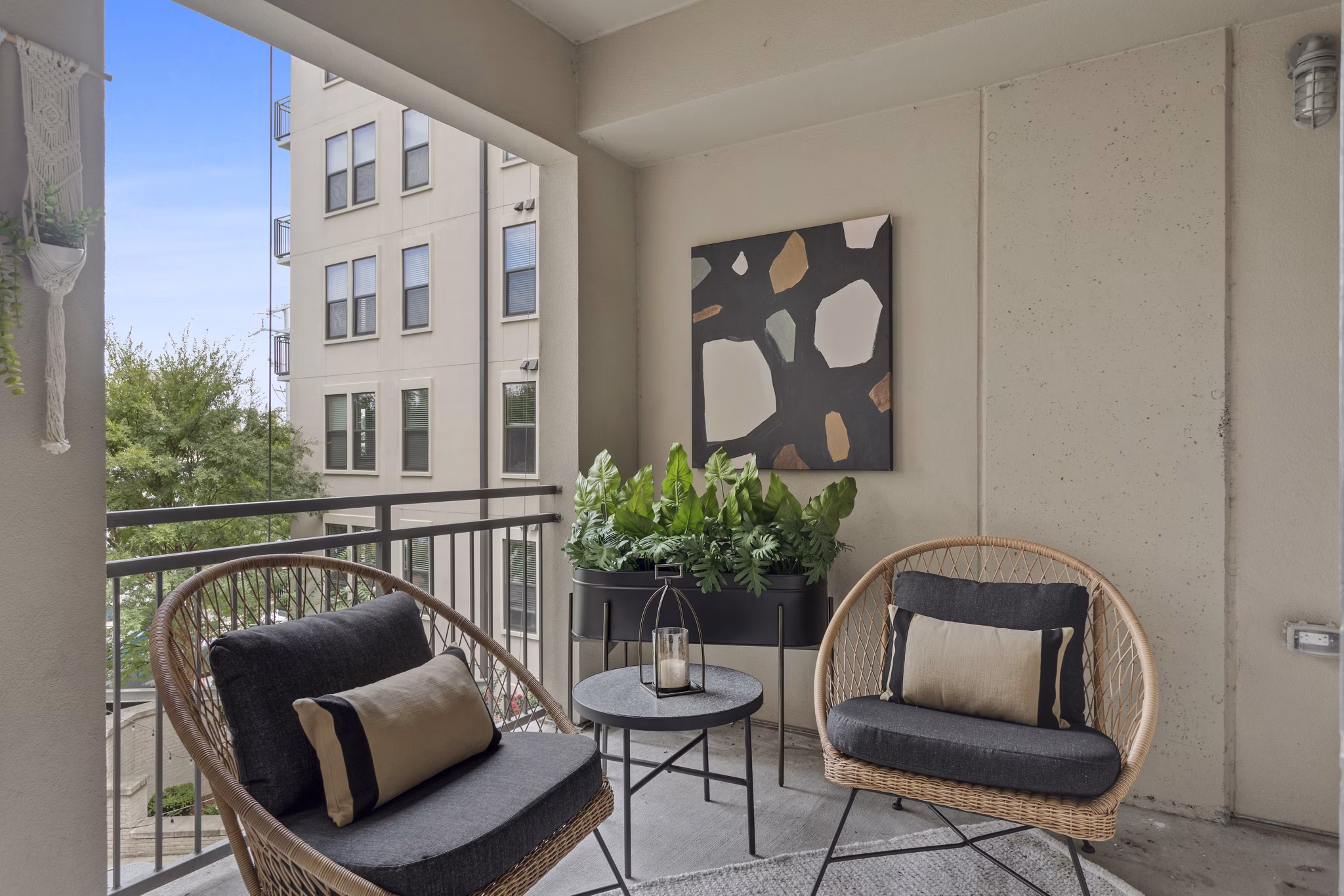Private balcony with modern seating at Elliston 23 Apartments, luxury living by Greystar