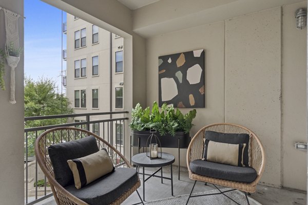 Private balcony with modern seating at Elliston 23 Apartments, luxury living by Greystar