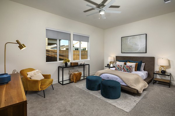 Cozy bedroom with modern furniture and large windows at SolTerra Apartments