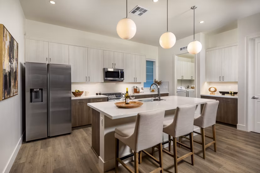 Modern kitchen with granite countertops and stainless steel appliances at SolTerra Apartments in luxury living community