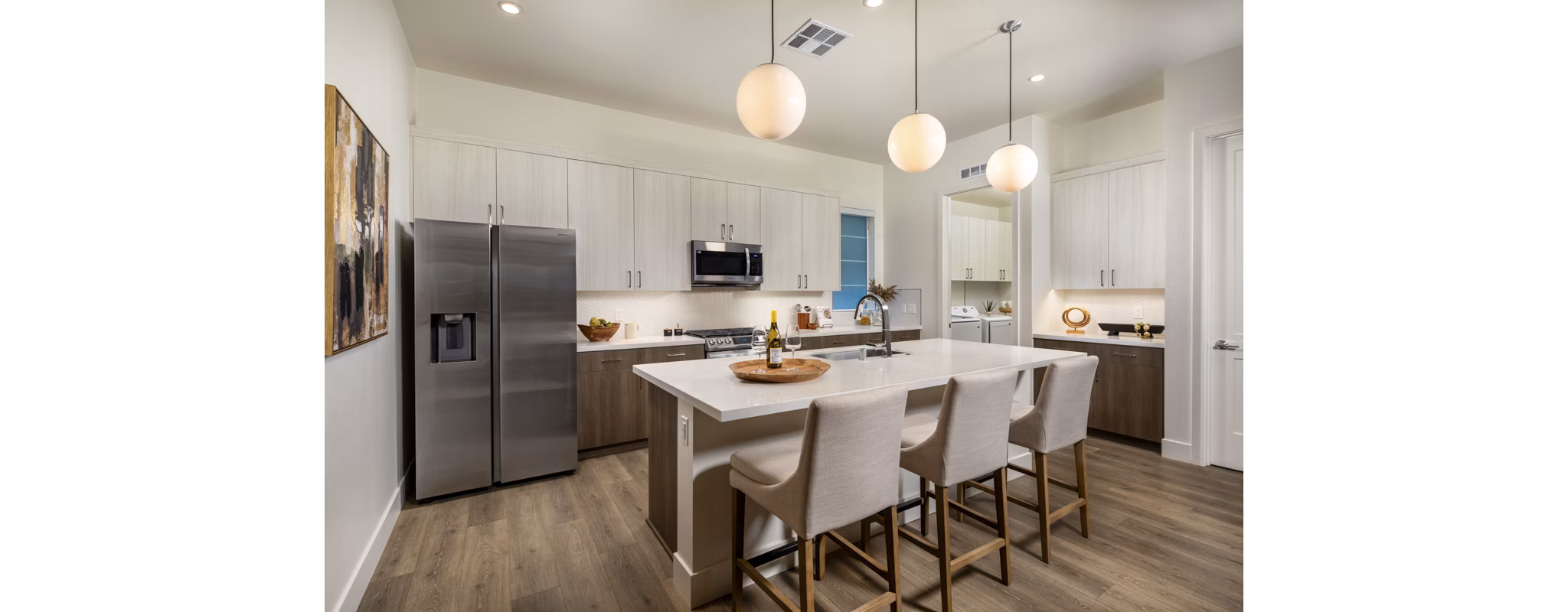 Modern kitchen with granite countertops and stainless steel appliances at SolTerra Apartments in luxury living community