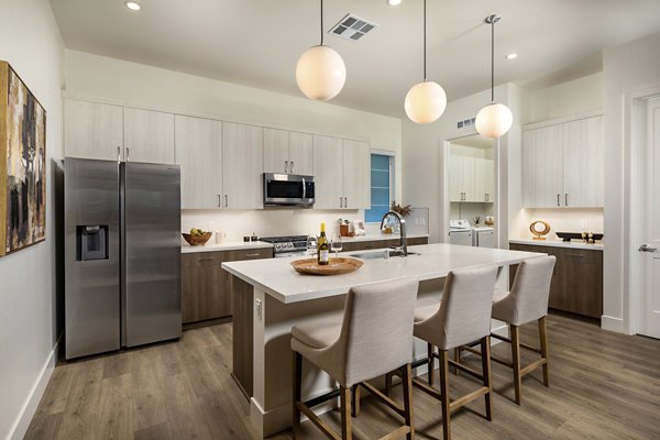 Modern kitchen with granite countertops and stainless steel appliances at SolTerra Apartments in luxury living community