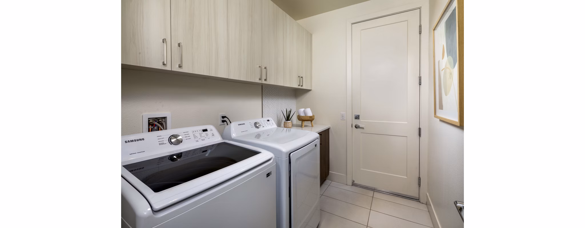 Laundry room featuring modern appliances at SolTerra Apartments, a luxury Greystar community in a prime location