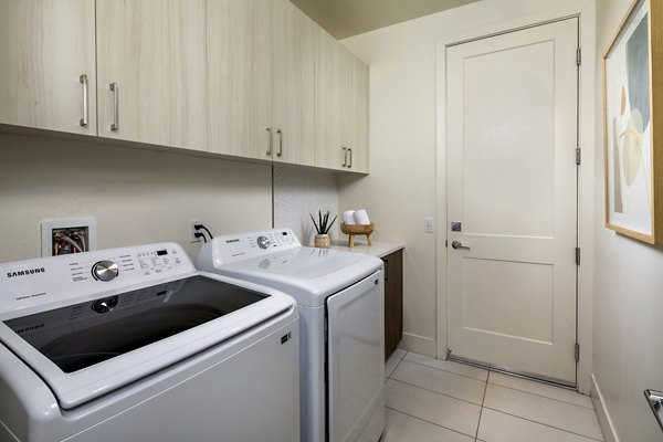 Laundry room featuring modern appliances at SolTerra Apartments, a luxury Greystar community in a prime location
