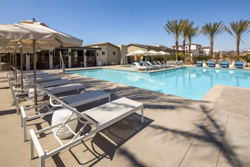 Resort-style pool with lounge chairs at SolTerra Apartments, a luxury Greystar community