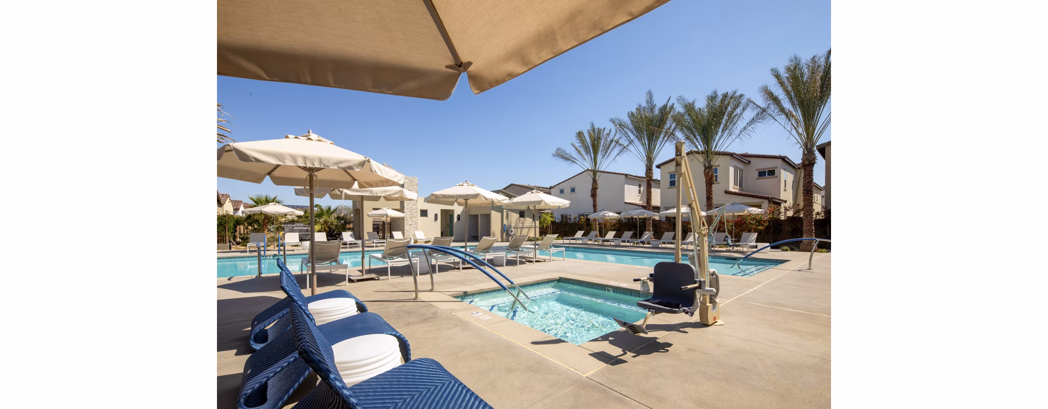 Resort-style pool with sun loungers at SolTerra Apartments, offering luxury amenities for a premium lifestyle experience