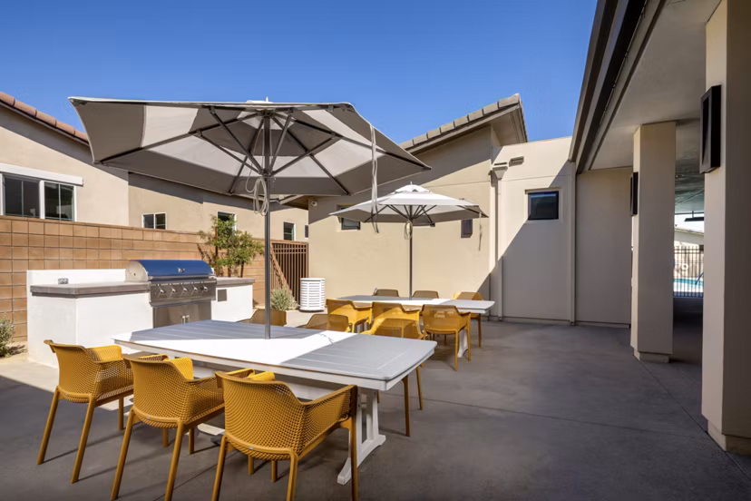 Spacious outdoor grill area with modern seating at SolTerra Apartments, perfect for entertaining in a luxury setting
