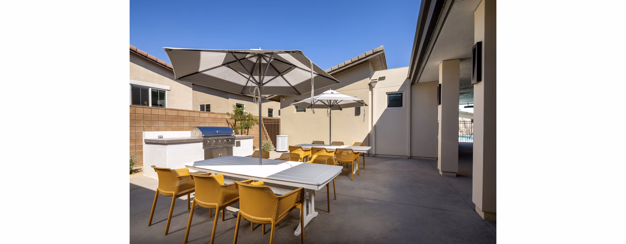 Spacious outdoor grill area with modern seating at SolTerra Apartments, perfect for entertaining in a luxury setting