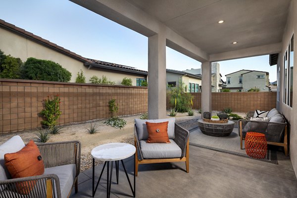 Elegant outdoor patio with modern seating at SolTerra Apartments, featuring lush greenery and ambient lighting for a relaxing atmosphere