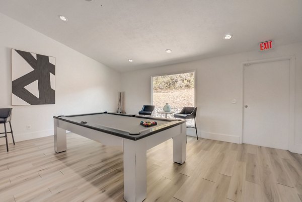 Game room with billiards and lounge seating at Brentwood Oaks Apartments